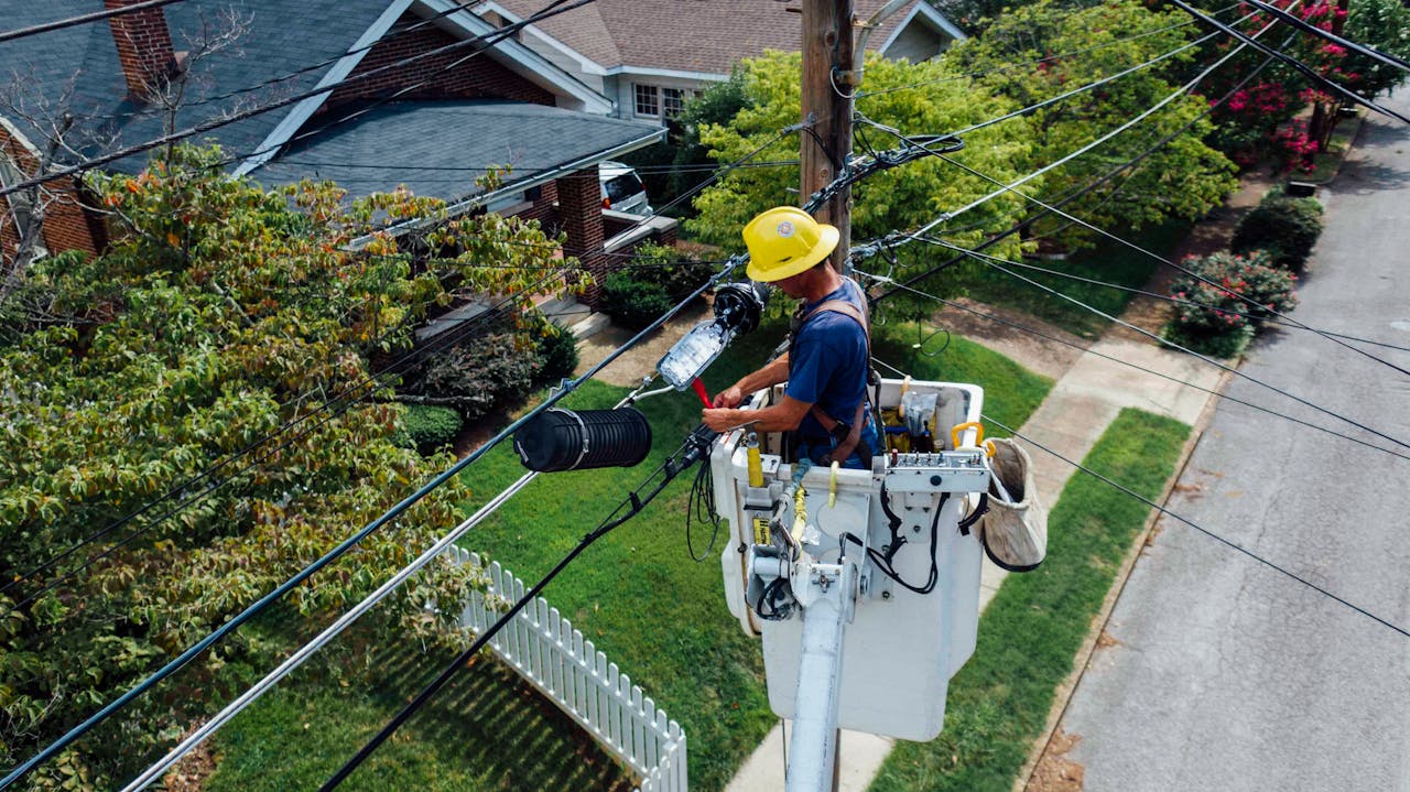 Utility technician working on fiber lines in residential neighborhood