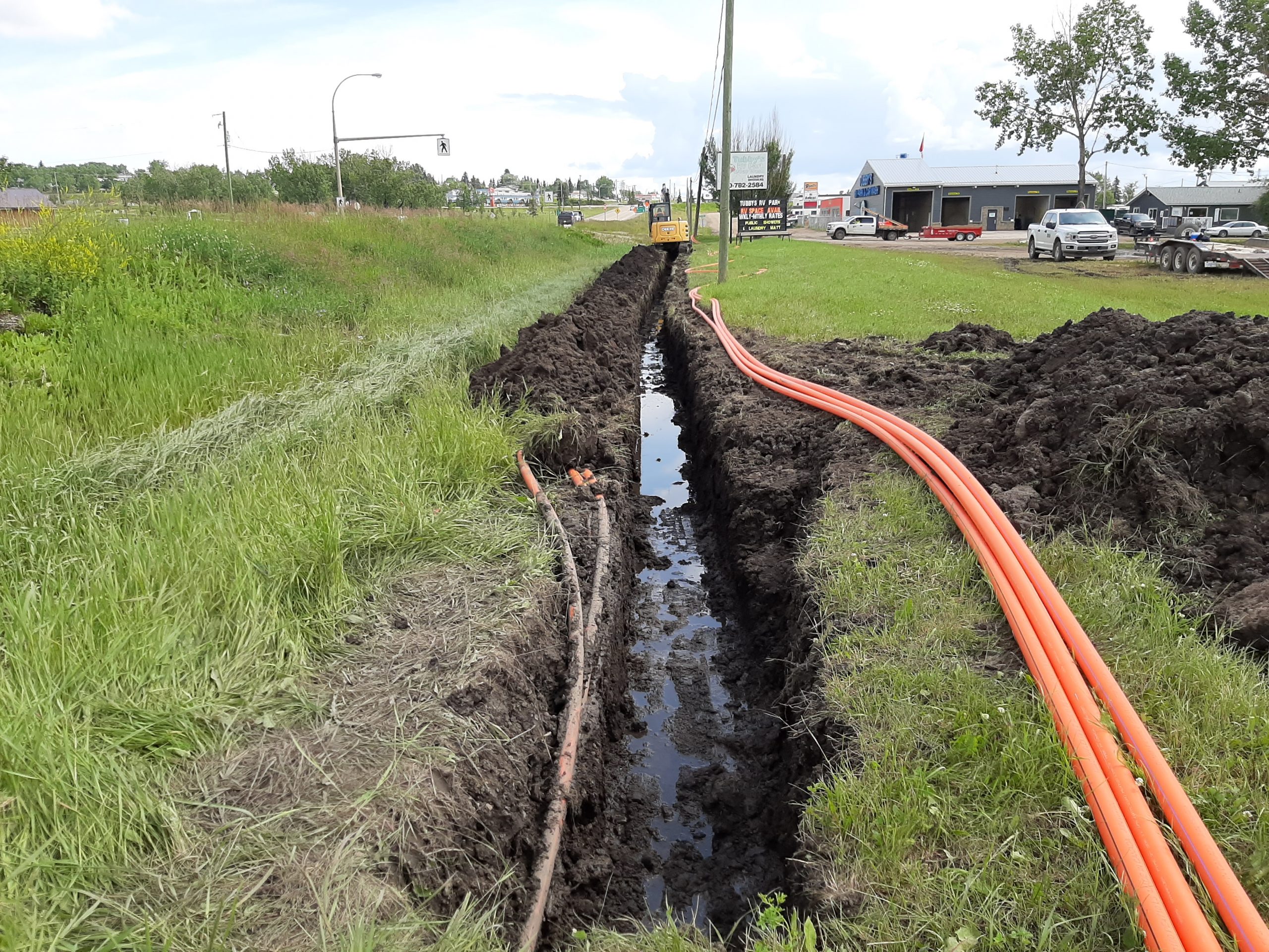 Underground fiber conduit trenching and installation